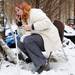 Alanna Gehringer uses a broken mirror to apply her makeup while sitting outside of her tent at Camp Take Notice on Tuesday. Melanie Maxwell I AnnArbor.com